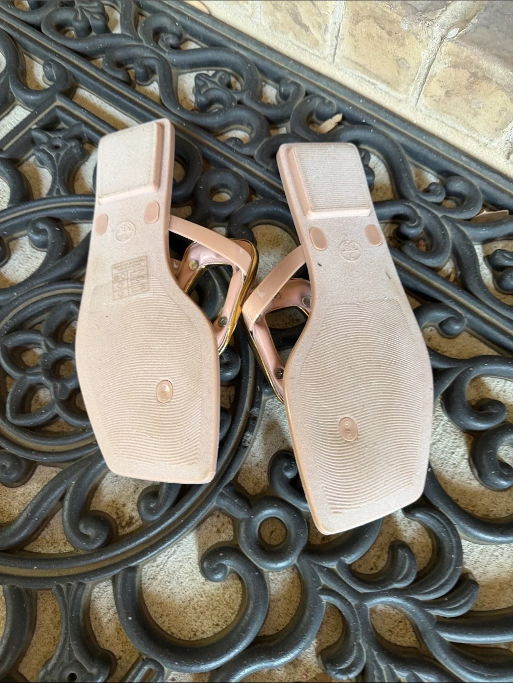 Women’s blush pink thong sandals with gold buckle